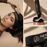 Woman wearing a wig with 'The Wig Whisperer' headband, close-up of the headband on a stand, and logo on a beige background.